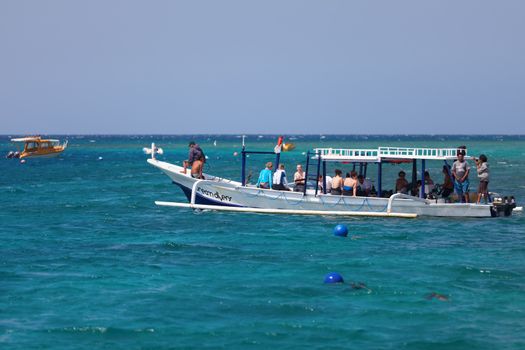 GILI, INDONESIA - SEP 15: Tourist divers on the traditional long boat on Sep 15, 2012 near Gili Trawangan island, Indonesia. Diving and snorkeling is popular attraction near island reefs.