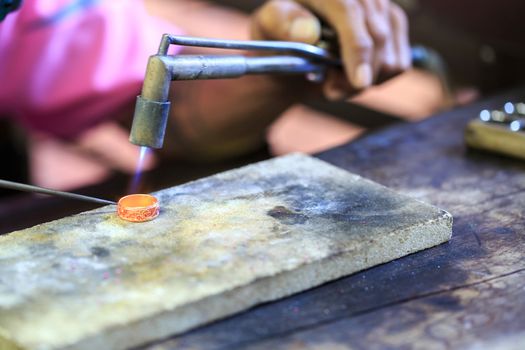 Goldsmith working with a thai traditional ring