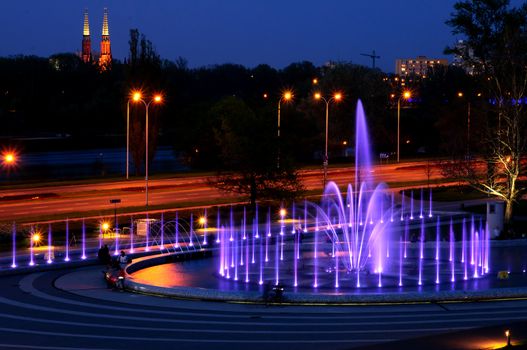 Warsaw landmark - illuminated fountain at night. Poland