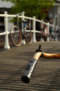 Handlebar Of An Old Bike On A Bridge Over A Canal In The Netherlands