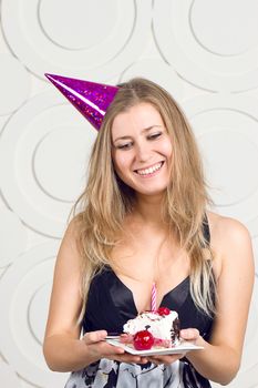 beautiful caucasian girl blowing candles on her cake