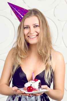beautiful caucasian girl blowing candles on her cake