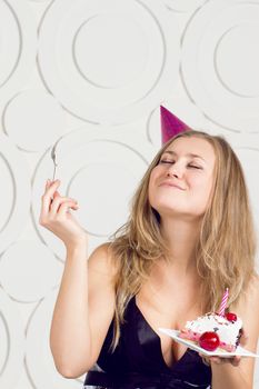 beautiful caucasian girl blowing candles on her cake