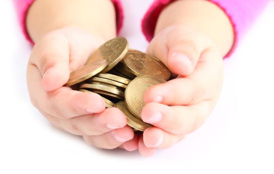 in the hands of a child holding a coin