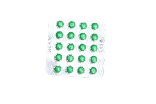 Packing green pills on white background