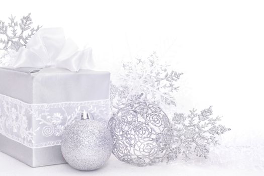 Christmas card with silver gift and decoration on white