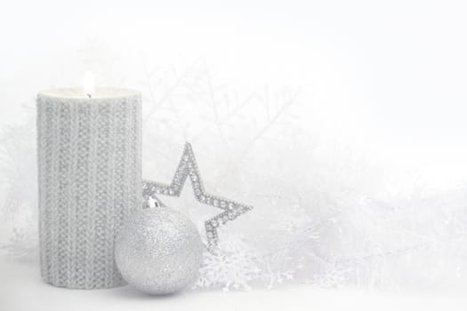 Christmas card with burning candle and decoration on white