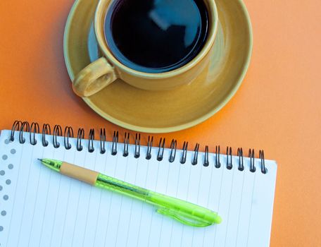 Notebooks pens note the glass coffee drinks.