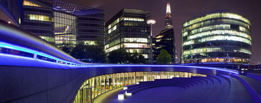 A night-time panoramic view of the 'The Scoop' - an outdoor amphitheatre in London.  The Shard can also be seen.