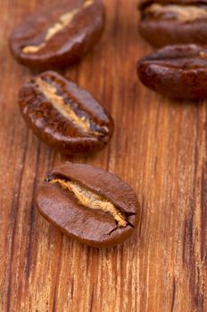 Roasted Coffee Beans closeup on Wooden background