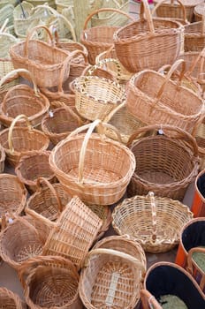 Full frame take of a heap of wickerwork baskets at a traditional street market stall