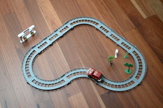 A toy race track on a wooden floor