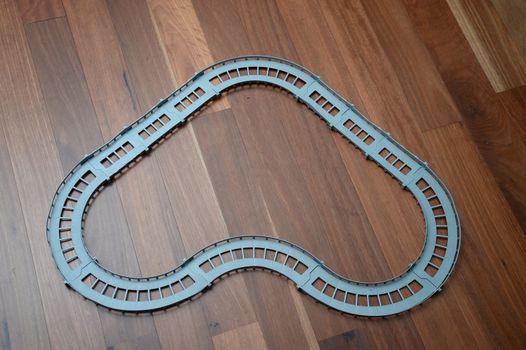 A toy race track on a wooden floor