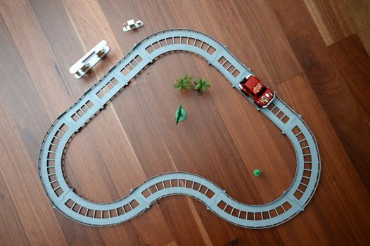A toy race track on a wooden floor