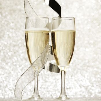 New year card with Champagne on shiny glitter background