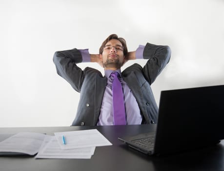 businessman at his desk with a laptop and papers