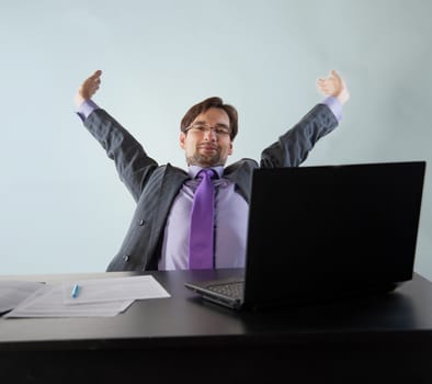 businessman at his desk with a laptop and papers