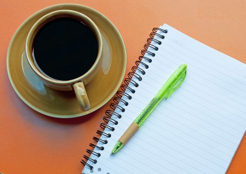 Notebooks pens note the glass coffee drinks.