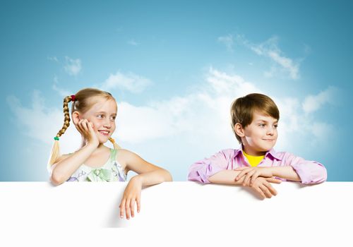 Image of cute kids holding blank white banner. Place for text