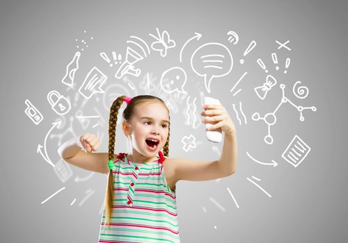 Image of little angry girl shouting in mobile phone