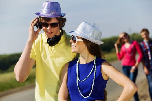 Young man and young woman outdoors. Summer vacation