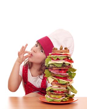 little girl with ok hand sign and tall sandwich