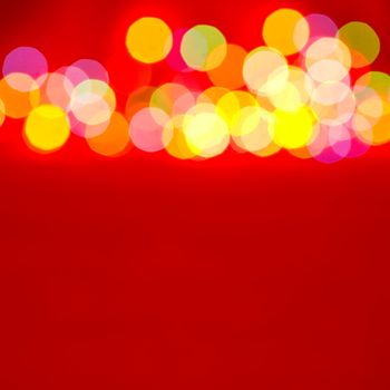 Blurred christmas lights on red background
