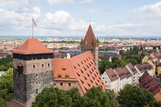 Pentagonal tower, with the Imperial Stables and Luginsland behind it, at Kaiserburg Imperial Castle in Nuremberg, Franconia, Bavaria, Germany. Nuremberg city in the background.