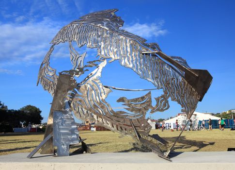 Bondi Beach, Australia - November 3,  2013: Sculpture By The Sea, Bondi 2013. Annual cultural event that showcases emerging artists from around the world  Sculpture titled Breach' by Michael Snape (NSW).  Medium stainless steel  Price $38000