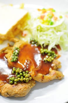 Pork pepper steak with bread and salad