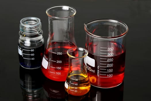 Laboratory Flasks Glassware with red, blue and yellow solutions