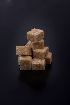 Photo of sugar cubes isolated on a black background