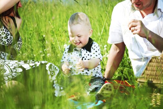  happy family on picnic in green grass