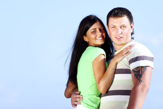 man and woman hug in the sky sea on background