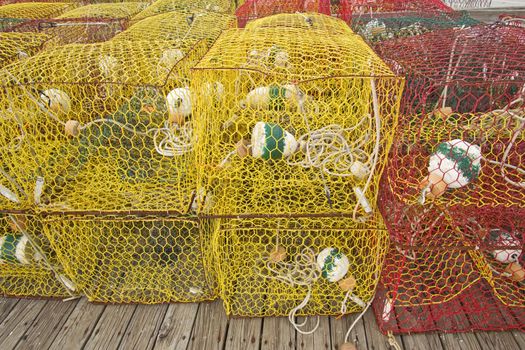 Yellow and red crab pots sit on a dock in Ocracoke Island, NorthCarolina, awaiting their deployment in Pamlico Sound
