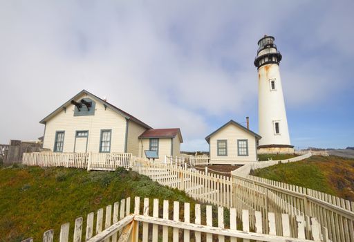 The Pigeon Point Lighthouse and white picket fence located in Pigeon Point Light Station State Historic Park between Half Moon Bay and Santa Cruz on the central California coast