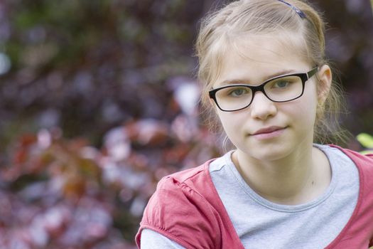 Young girl in park in spring day - portrait