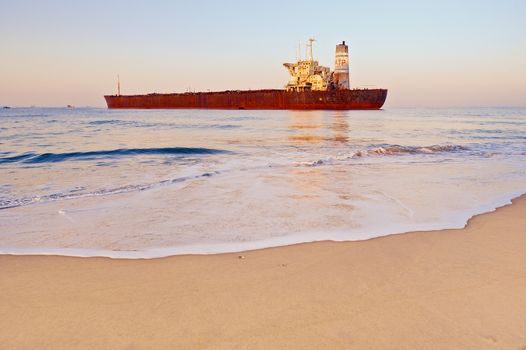 Rusty ship on the shoreline in the Goa, India