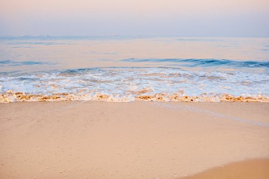 Soft wave on the sandy beach in the morning