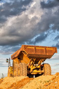 Empty heavy mining truck at sunset