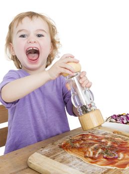 child with pepper making fresh pizza. studio shot isolated on white background