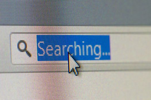 Close up macro of internet browser address bar with searching text selected with mouse arrow pointer.