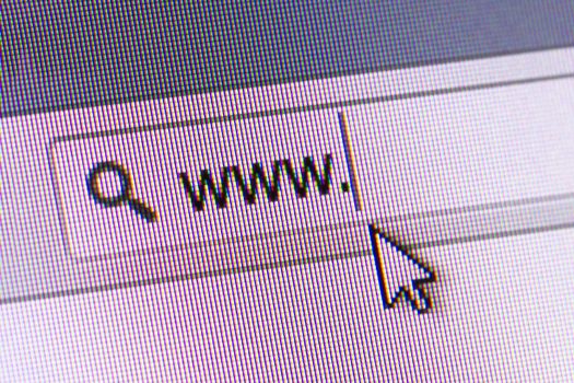 Mouse arrow pointing internet browser address bar with www text, close up of computer screen.
