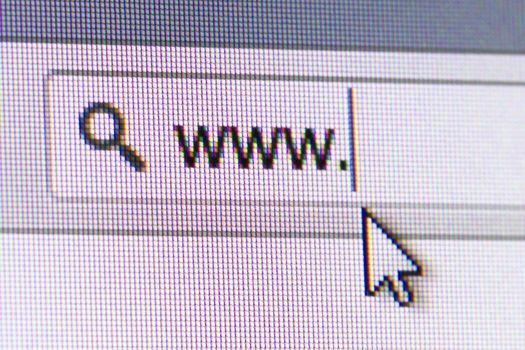 Close up of computer screen internet browser address bar, www text and arrow mouse cursor