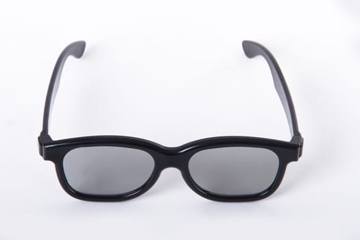 3D glasses with black frame for cinema, isolated on white background.