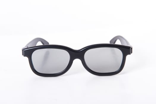 3D glasses with black frame for cinema, front view, isolated on white background.