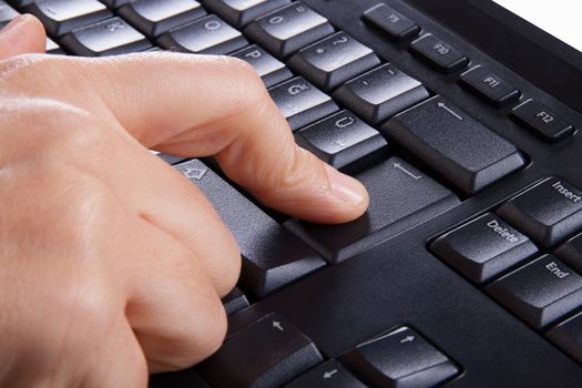 Index finger pressing enter key, button on keyboard.