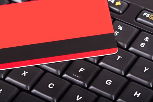 Close up view of credit card on black computer keyboard.