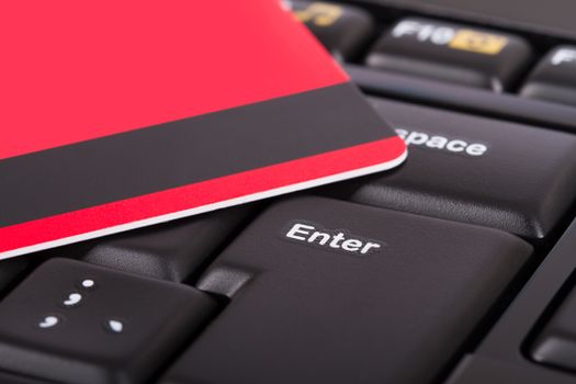 Close up view of credit card on black computer keyboard.