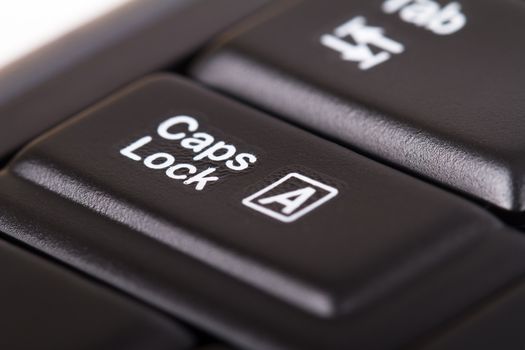 Close up view of caps lock key on black keyboard.
